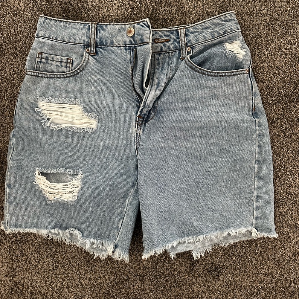 mid length ripped light wash shorts